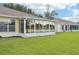 A well-manicured lawn leads up to the enclosed sunroom and tranquil lake at 2218 Brookfield Greens Cir # 82, Sun City Center, FL 33573