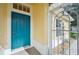 Bright blue front door with a security screen and tiled porch at 2218 Brookfield Greens Cir # 82, Sun City Center, FL 33573
