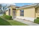 Screened in entry way with lush, green landscaping and a concrete path at 2218 Brookfield Greens Cir # 82, Sun City Center, FL 33573