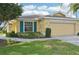 Close up of the home's front exterior and beautiful landscaping with a two-car garage at 2218 Brookfield Greens Cir # 82, Sun City Center, FL 33573