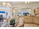 Bright kitchen with a breakfast nook featuring tile flooring, wood cabinets, and a round glass table with chairs at 2218 Brookfield Greens Cir # 82, Sun City Center, FL 33573