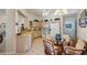 Bright eat-in kitchen with tile flooring, wood cabinets, and a round glass table surrounded by chairs at 2218 Brookfield Greens Cir # 82, Sun City Center, FL 33573