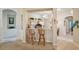 Bright kitchen bar area features tile flooring, wood cabinets, bar seating, and natural light at 2218 Brookfield Greens Cir # 82, Sun City Center, FL 33573