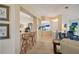 Bright living room with a kitchen bar area, tile flooring, wood cabinets, and bar seating at 2218 Brookfield Greens Cir # 82, Sun City Center, FL 33573