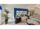 Open floorplan in the living room with ample lighting and view of the backyard at 2218 Brookfield Greens Cir # 82, Sun City Center, FL 33573