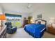 Main bedroom with lake view, ceiling fan, soft carpet, and a cozy reading chair at 2218 Brookfield Greens Cir # 82, Sun City Center, FL 33573