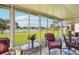 Inviting sunroom features panoramic views of the lake, offering a peaceful retreat with plenty of natural light at 2218 Brookfield Greens Cir # 82, Sun City Center, FL 33573