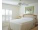 Bright bedroom featuring plantation shutters and neutral decor at 2325 Brookfield Greens Cir # 41, Sun City Center, FL 33573
