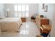 Bright bedroom with white walls, plantation shutters, and tiled floors at 2325 Brookfield Greens Cir # 41, Sun City Center, FL 33573