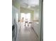 Bright eat-in kitchen with white cabinets, tile floor, and access to patio at 2325 Brookfield Greens Cir # 41, Sun City Center, FL 33573