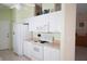 Clean white kitchen with range, microwave, refrigerator, and light countertops at 2325 Brookfield Greens Cir # 41, Sun City Center, FL 33573