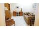 Comfortable office with patterned sofa, built-in shelving, desk, and tiled flooring at 2325 Brookfield Greens Cir # 41, Sun City Center, FL 33573