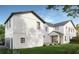 A modern home with a clean white stucco exterior, black framed windows, and a detached garage, set on a well-manicured lawn at 2534 2Nd S Ave, St Petersburg, FL 33712