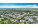 Expansive aerial view of a neighborhood with lush green trees and manicured lawns under a bright blue sky at 2601 Brookville Dr, Valrico, FL 33596