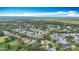 Expansive aerial view of a suburban neighborhood with mature trees and various home styles at 2601 Brookville Dr, Valrico, FL 33596