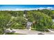 Aerial view of a single-story home with lush trees and a well-manicured lawn at 2601 Brookville Dr, Valrico, FL 33596