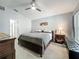 Bedroom boasts neutral walls, ceiling fan, stylish decor, and ample natural light at 2601 Brookville Dr, Valrico, FL 33596
