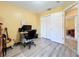Bright bedroom features a computer and white closet doors at 2601 Brookville Dr, Valrico, FL 33596