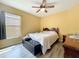 Inviting bedroom with a ceiling fan, wood-look floors, and natural light at 2601 Brookville Dr, Valrico, FL 33596