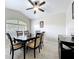 Elegant dining room with a ceiling fan, large window, and a classic dark wood dining set at 2601 Brookville Dr, Valrico, FL 33596