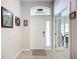 Bright foyer showcasing tile flooring, a white front door with side window, and a glimpse into adjacent rooms at 2601 Brookville Dr, Valrico, FL 33596