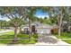 Traditional home with a well-manicured lawn, mature trees, and a two-car garage at 2601 Brookville Dr, Valrico, FL 33596