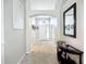 Spacious hallway with tile flooring, showcasing an archway and decorative console table at 2601 Brookville Dr, Valrico, FL 33596