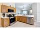 Modern kitchen with stainless steel appliances and a view into the living room at 2601 Brookville Dr, Valrico, FL 33596