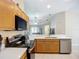 Well-lit kitchen with stainless steel appliances, plenty of counter space, and tile flooring at 2601 Brookville Dr, Valrico, FL 33596