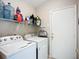 Functional laundry room with modern appliances and wire shelving for storage at 2601 Brookville Dr, Valrico, FL 33596