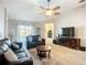 Cozy living room featuring tile flooring, a ceiling fan, and sliding glass doors to the pool at 2601 Brookville Dr, Valrico, FL 33596