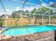 Beautiful screened-in pool with brick patio, landscaping, and refreshing blue water at 2601 Brookville Dr, Valrico, FL 33596