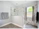 Stylish bathroom features a glass-enclosed shower with marble-look tile and a window for natural light at 2601 Brookville Dr, Valrico, FL 33596