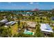 A vibrant coastal community with a home, swimming pool, lush landscaping, park, waterways and waterfront scenery at 3111 S De Bazan Ave, St Pete Beach, FL 33706
