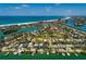 Picturesque aerial view of a coastal home on the water, emphasizing its waterfront location and community amenities at 3111 S De Bazan Ave, St Pete Beach, FL 33706
