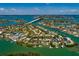 Dramatic aerial of a waterfront community, emphasizing canal access and its unique positioning near bridges and waterways at 3111 S De Bazan Ave, St Pete Beach, FL 33706