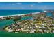 Captivating aerial view showcasing the property nestled in a vibrant coastal community with waterfront access at 3111 S De Bazan Ave, St Pete Beach, FL 33706