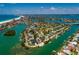 Stunning aerial view of a home situated on a canal, complete with boat access and neighborhood amenities at 3111 S De Bazan Ave, St Pete Beach, FL 33706