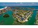 Wide aerial shot of a waterfront community, featuring homes with canal access and proximity to coastal attractions at 3111 S De Bazan Ave, St Pete Beach, FL 33706