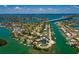 Scenic aerial perspective of a home in a coastal neighborhood, showcasing waterfront living near bridges and islands at 3111 S De Bazan Ave, St Pete Beach, FL 33706