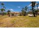 Single-story home with a large backyard and patio, perfect for a comfortable living at 3111 S De Bazan Ave, St Pete Beach, FL 33706