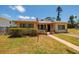 Charming coastal home with a well-maintained yard, featuring lush landscaping and a welcoming entryway at 3111 S De Bazan Ave, St Pete Beach, FL 33706