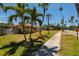 Charming coastal home with a well-manicured lawn, lush tropical landscaping, and inviting curb appeal at 3111 S De Bazan Ave, St Pete Beach, FL 33706