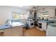 Bright kitchen with white cabinets, a white oven, and a view to the backyard at 3111 S De Bazan Ave, St Pete Beach, FL 33706