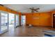 Spacious living room with hardwood floors and a bright orange paint color at 3111 S De Bazan Ave, St Pete Beach, FL 33706