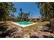 Backyard pool with tropical landscaping, offering a refreshing oasis for relaxation and enjoyment at 3111 S De Bazan Ave, St Pete Beach, FL 33706