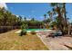 Refreshing pool in a private backyard oasis surrounded by lush tropical landscaping and serene surroundings at 3111 S De Bazan Ave, St Pete Beach, FL 33706