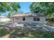 Backyard of home with a concrete slab, white exterior walls, and windows at 3256 Adrian Ave, Largo, FL 33774