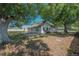 Large backyard shaded by mature trees and lush greenery at 3256 Adrian Ave, Largo, FL 33774