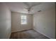 Cozy bedroom with carpet flooring, a ceiling fan, and a view of the backyard at 3256 Adrian Ave, Largo, FL 33774